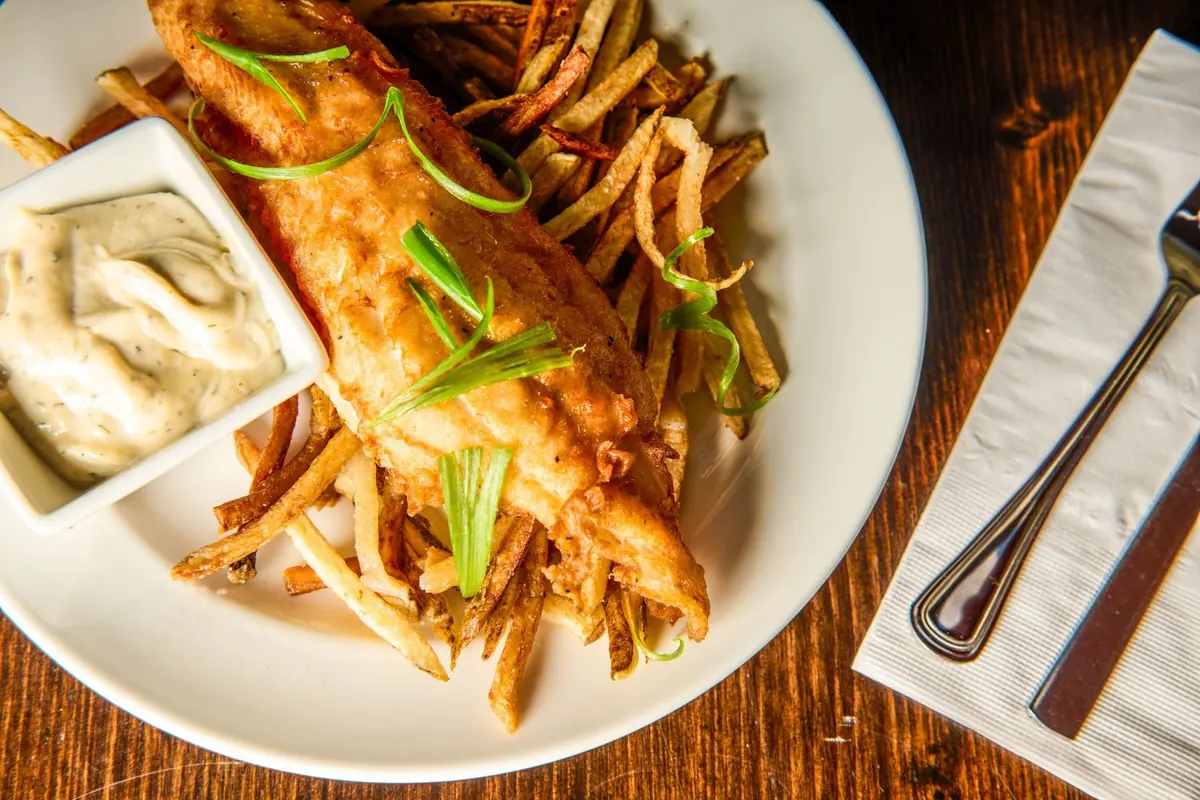 Fish and chips from overhead on dark wood