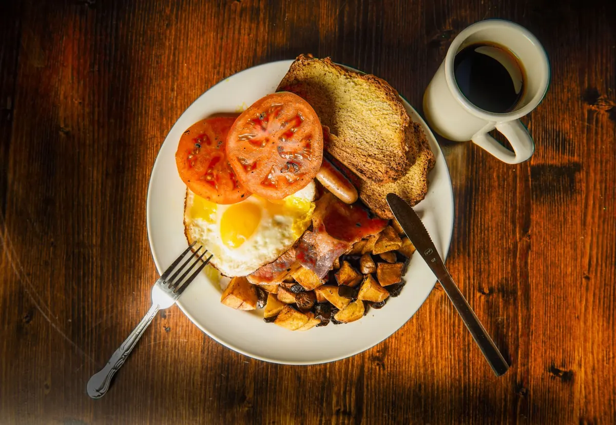 Full breakfast with eggs, tomato and coffee, shot from above
